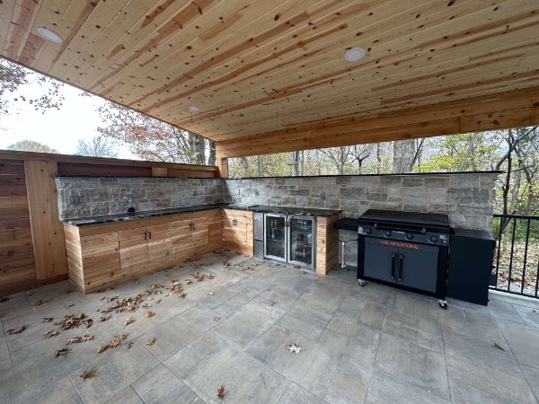 outdoor kitchen with stainless steel appliances and a wood shade structure